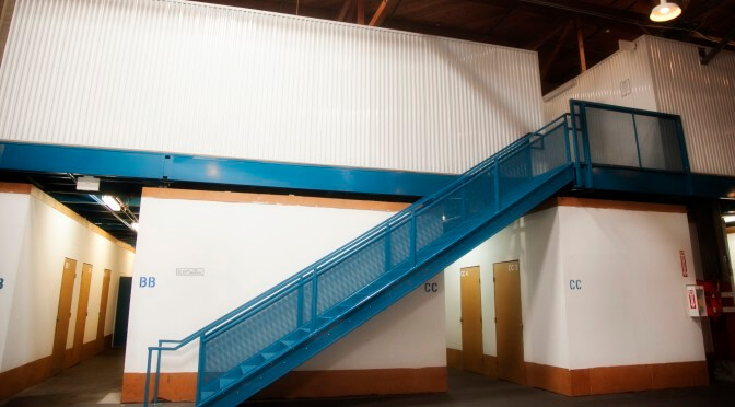 Inside storage facility with a blue staircase leading to more indoor storage units