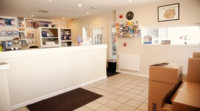 Facility office with moving and packing supplies hanging on walls and on shelves