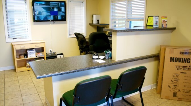 Inside facility office overlooking front desk area with two chairs pulled up to the desk