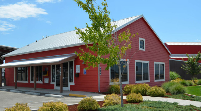 View of facility office entrance with a parking lot