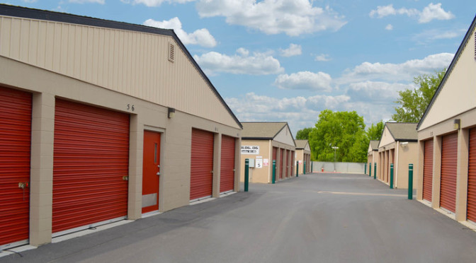 Area of large, outdoor storage units with red doors in a clean environment