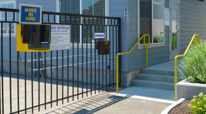 Exterior entrance to a Central Self Storage facility office and a gated entrance